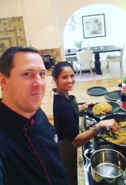 Nic and Yuli cooking together in the kitchen