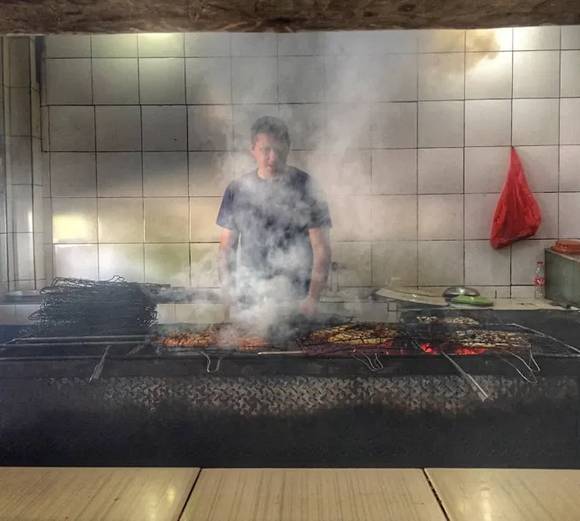 The Yunic culinary team cooking over open fire and smoke